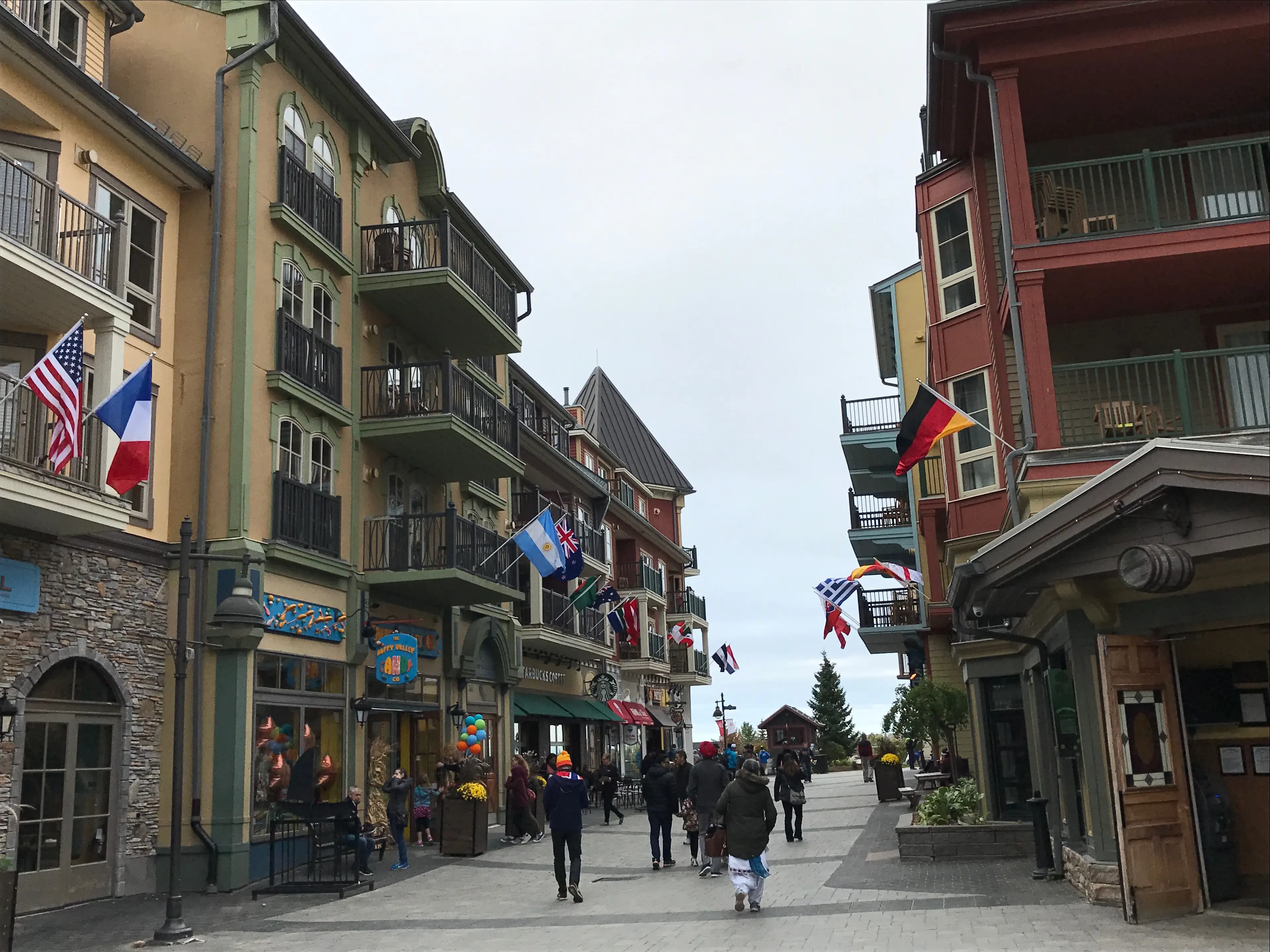 A mountain village street lined with flags on race weekend